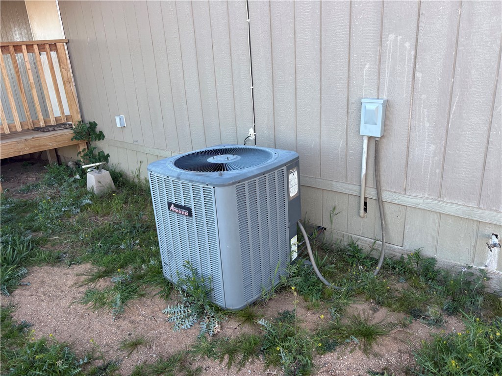 4938 Mormon Flat Road Golden Valley, AZ 86413 - Photo 20 of 23 Exterior view of a central AC unit and crawl space
