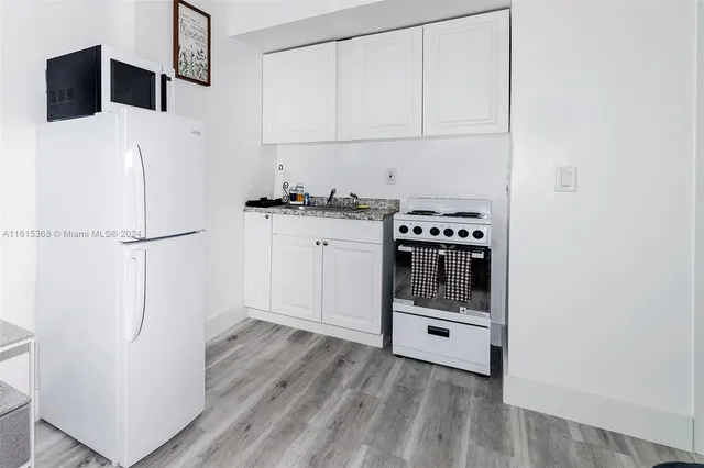 a kitchen with a refrigerator and a stove