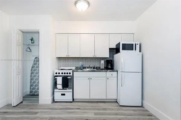 a kitchen with a white cabinets and white appliances