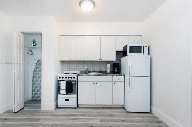 a kitchen with a white cabinets and white appliances