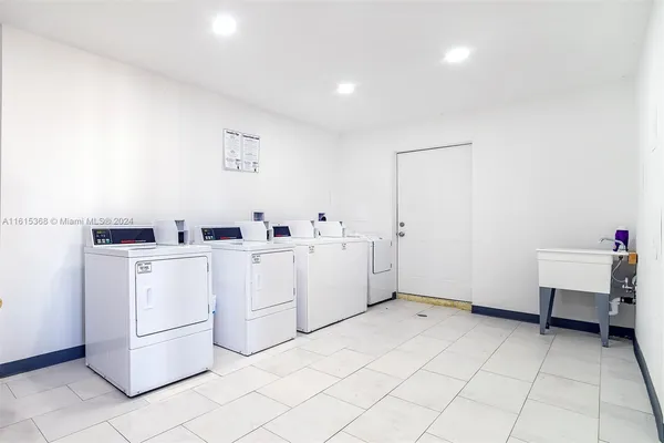 a room with cabinets and washer dryer