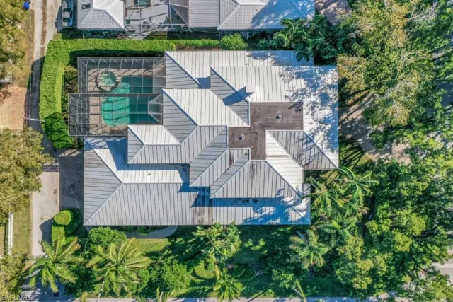 an aerial view of a house with garden space and street view