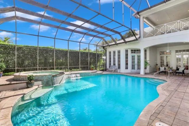a view of a backyard with swimming pool and sitting area