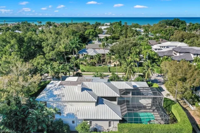 a view of a patio with furniture and a garden