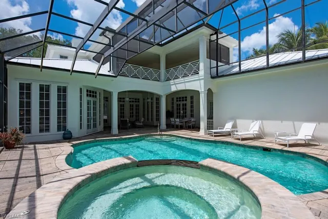 a swimming pool with patio outdoor seating and yard