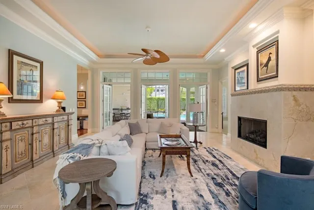 a living room with furniture a fireplace and a table