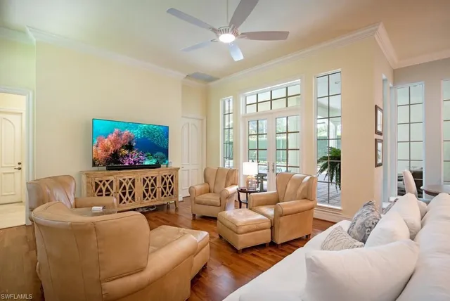 a bedroom with furniture and a large window