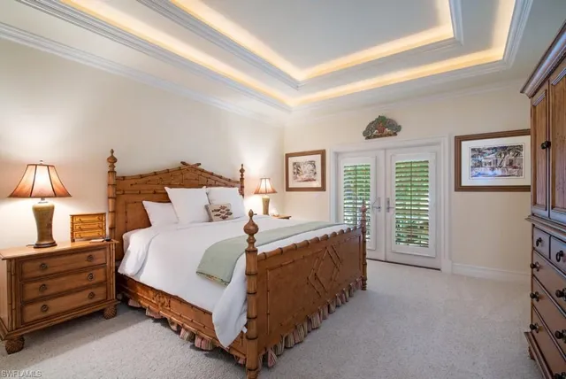 a spacious bedroom with two beds and a window