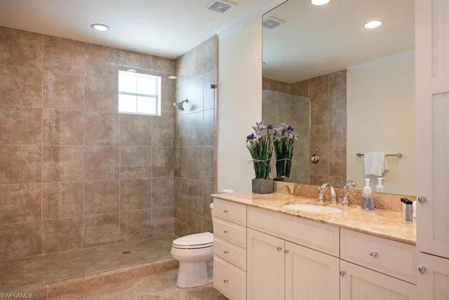 a spacious bedroom with a bed and a large window