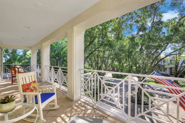 a view of balcony with furniture and trees