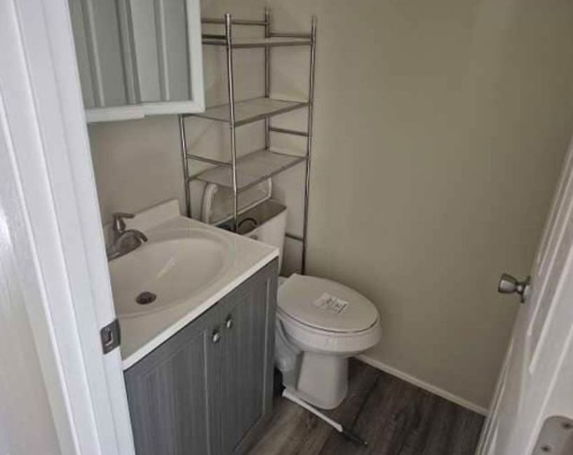 225 Ogden Street Capron, IL 61012 - Photo 12 of 16 a bathroom with a sink toilet and vanity