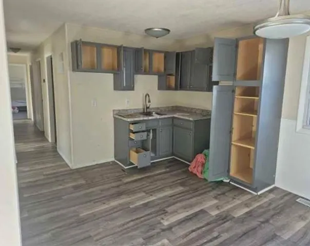 a kitchen with stainless steel appliances granite countertop a refrigerator and a stove