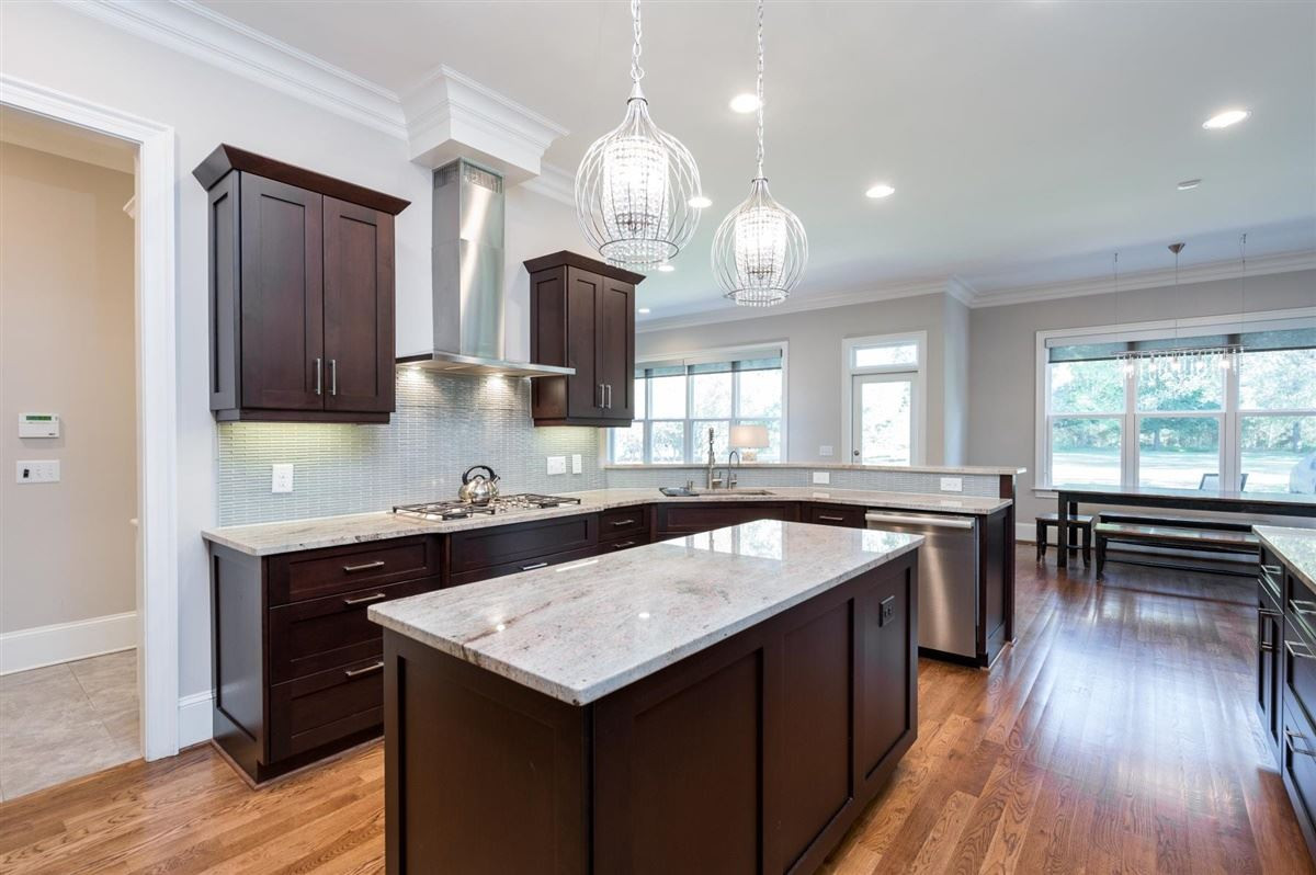 12904 Grovehurst Drive Raleigh, NC 27613 - Photo 11 of 30 Peninsula Bar wraps this open modern kitchen - Seat 6 easily. Adjacent sizable breakfast room and family room, makes this open space great for entertaining kitchen