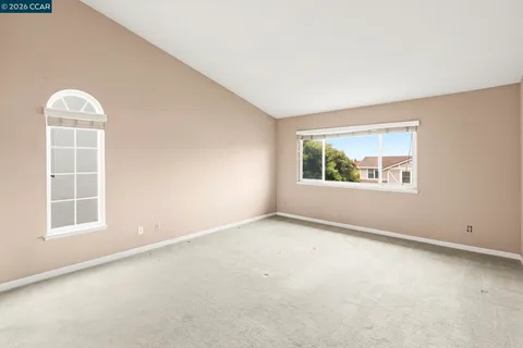 a view of an empty room with a kitchen