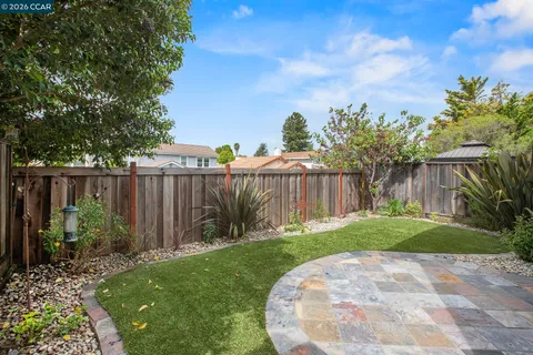 a view of garden with wooden fence