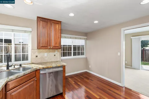 a kitchen with granite countertop wooden floors and sink