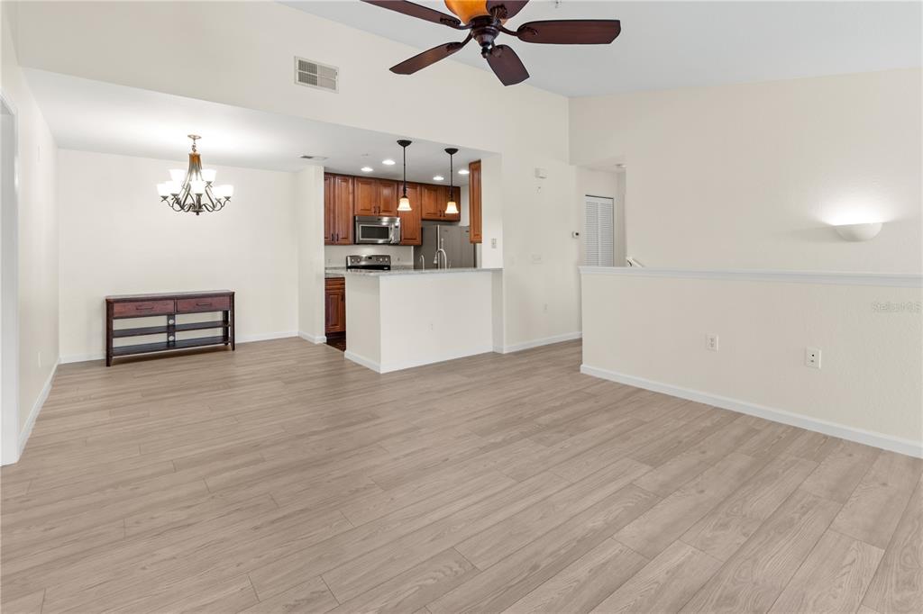 8911 Manor Loop, Unit 208 Lakewood Ranch, FL 34202 - Photo 11 of 49 a view of a livingroom with wooden floor and a ceiling fan