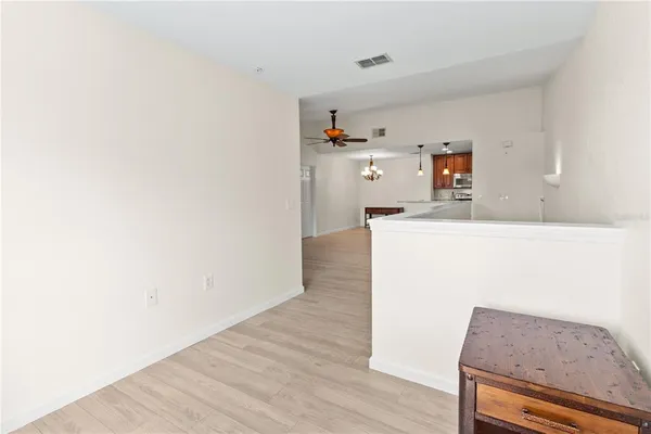 a kitchen with granite countertop white cabinets and wooden floor