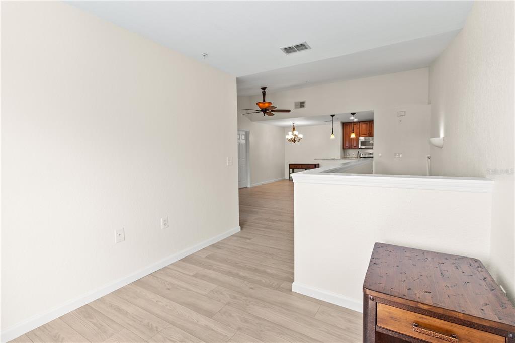 8911 Manor Loop, Unit 208 Lakewood Ranch, FL 34202 - Photo 12 of 49 a kitchen with granite countertop white cabinets and wooden floor