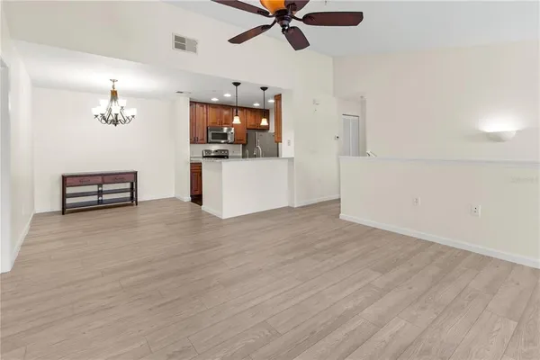 a view of a livingroom with wooden floor and a ceiling fan