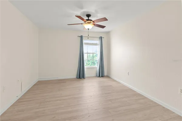 a view of a livingroom with a ceiling fan and window