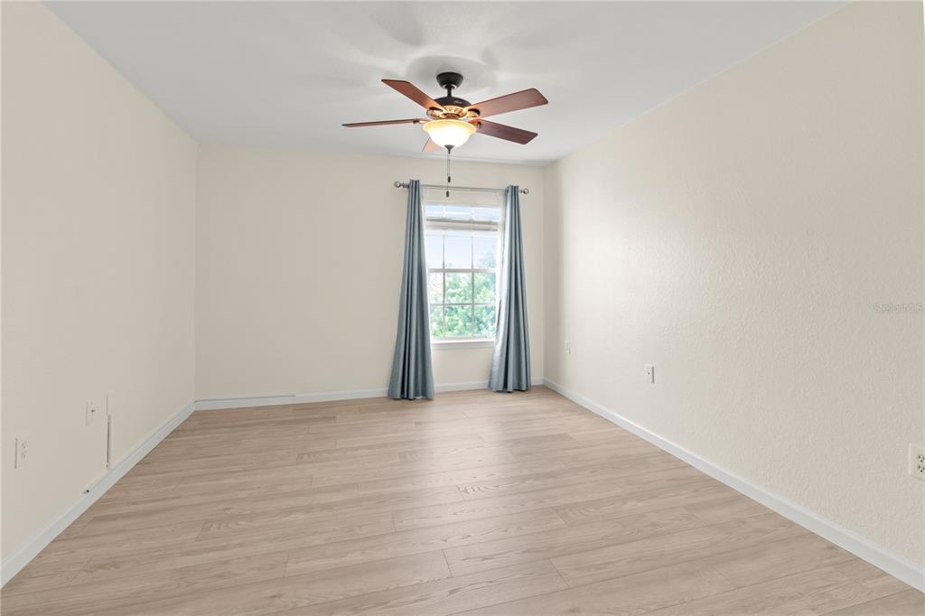 8911 Manor Loop, Unit 208 Lakewood Ranch, FL 34202 - Photo 16 of 49 a view of a livingroom with a ceiling fan and window