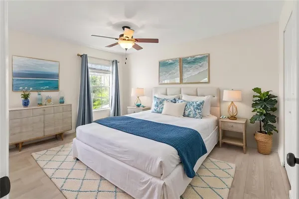 a bedroom with a large bed and a chandelier