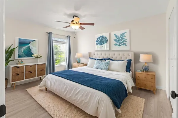 a view of a livingroom with a ceiling fan and window