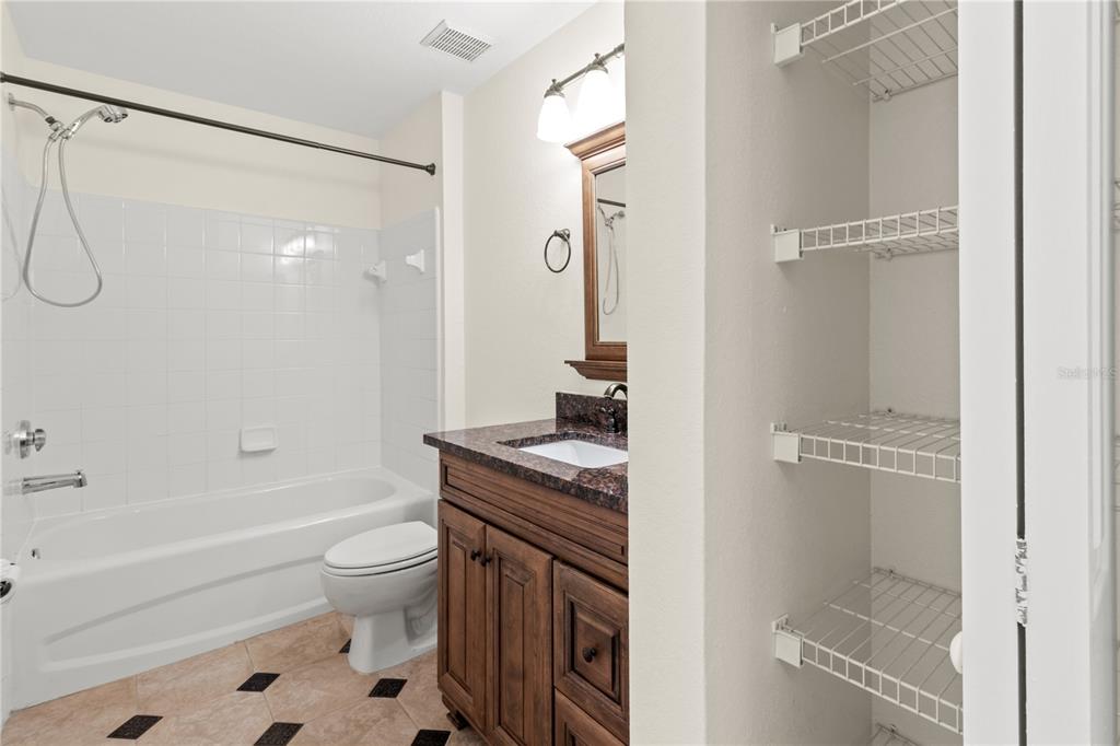 8911 Manor Loop, Unit 208 Lakewood Ranch, FL 34202 - Photo 19 of 49 a bathroom with a granite countertop sink toilet and shower