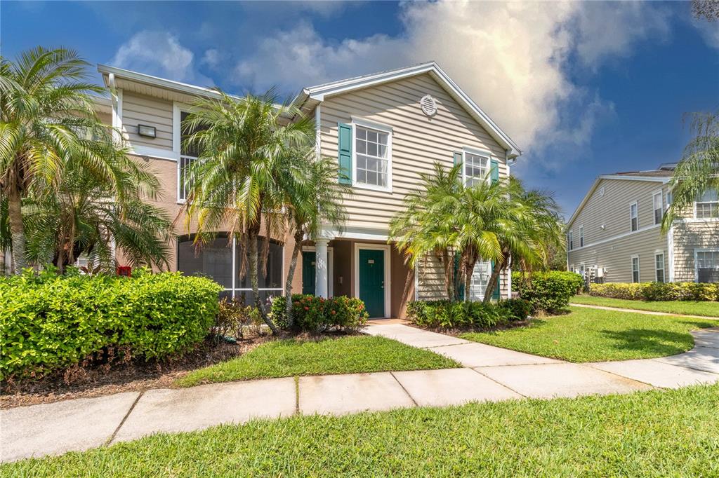 8911 Manor Loop, Unit 208 Lakewood Ranch, FL 34202 - Photo 2 of 49 a front view of a house with a yard