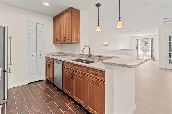 a kitchen with a sink cabinets and wooden floor