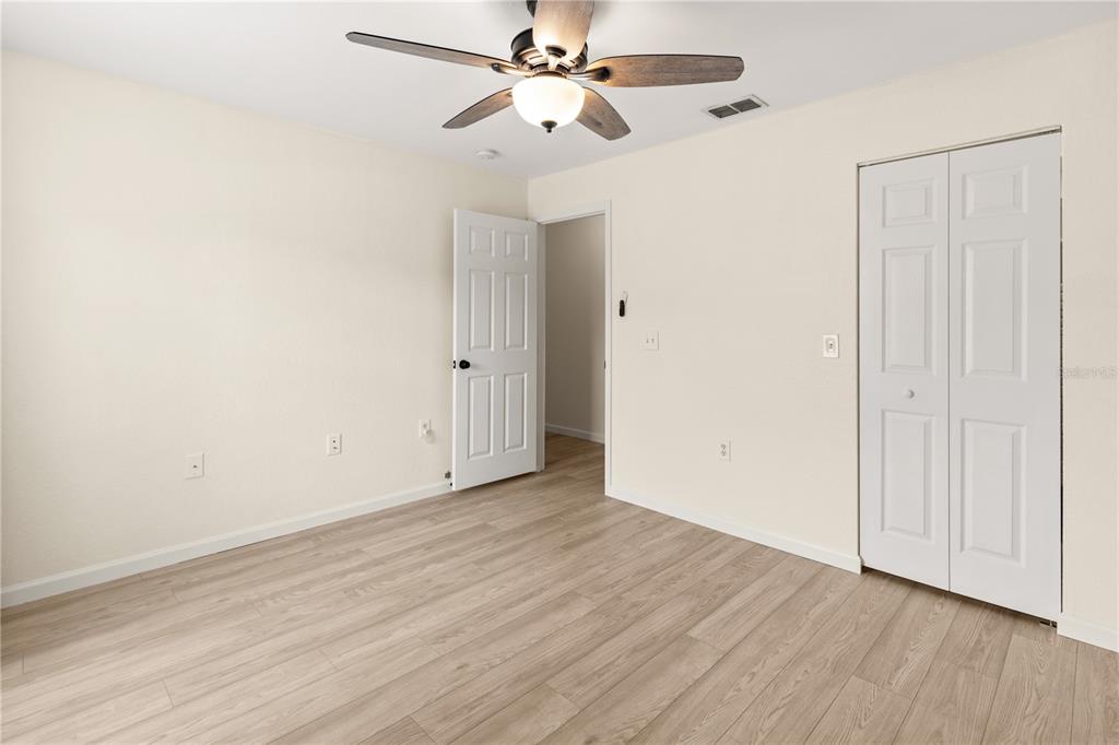 8911 Manor Loop, Unit 208 Lakewood Ranch, FL 34202 - Photo 29 of 49 a view of an empty room with wooden floor