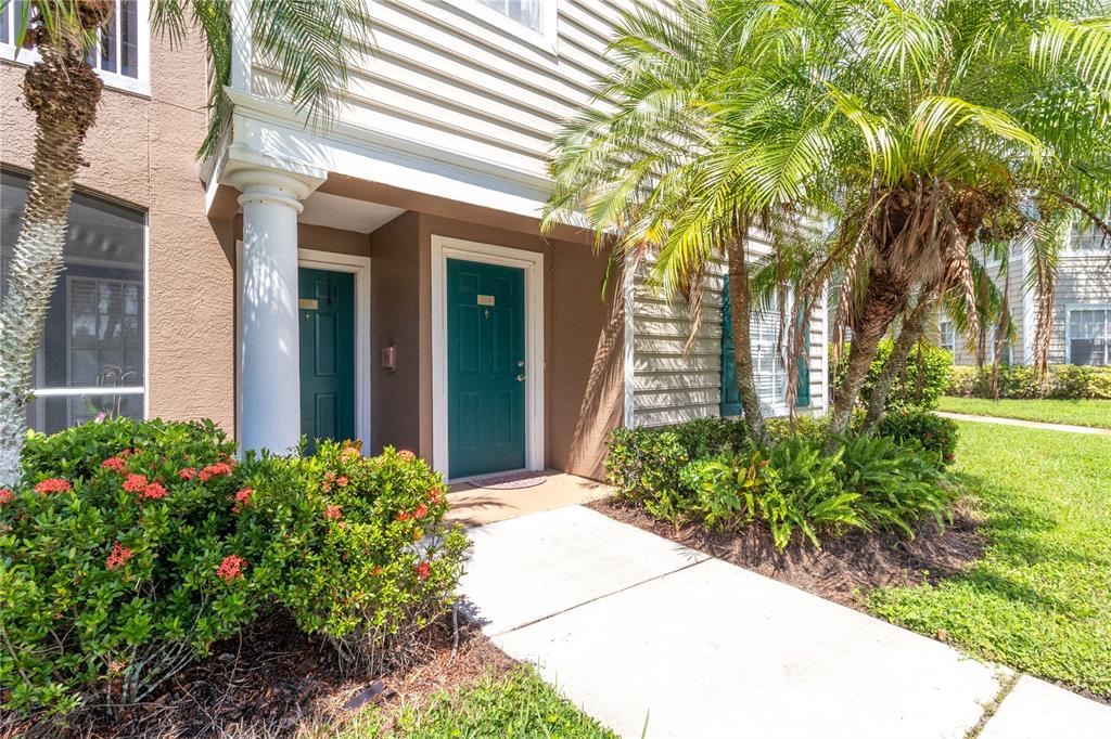 8911 Manor Loop, Unit 208 Lakewood Ranch, FL 34202 - Photo 3 of 49 a front view of a house with garden