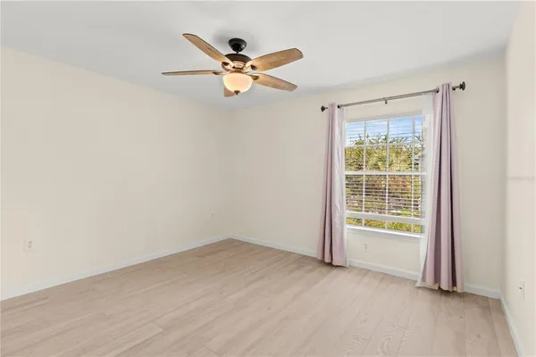 a view of an empty room with wooden floor