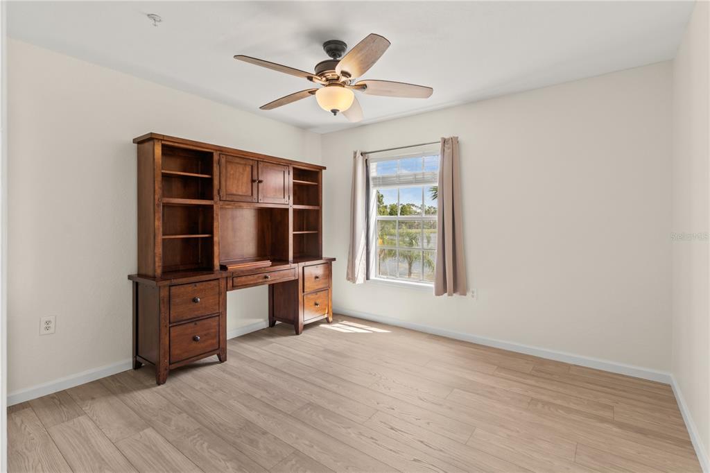 8911 Manor Loop, Unit 208 Lakewood Ranch, FL 34202 - Photo 31 of 49 an empty room with cabinet and windows