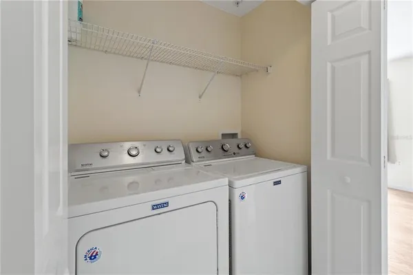 an empty room with cabinet and windows