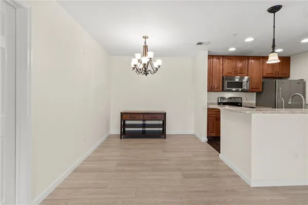 a view of kitchen with livingroom and wooden floor