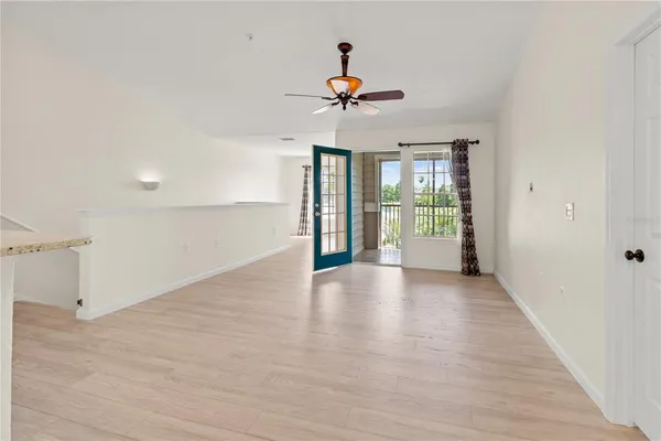 a hallway with a dining table and a chandelier