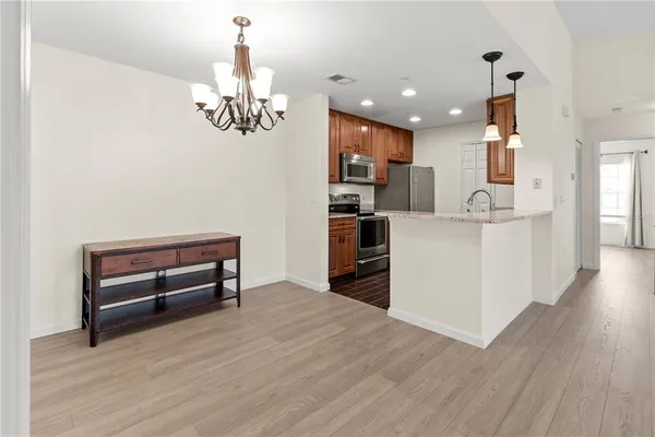 a kitchen with refrigerator and sink