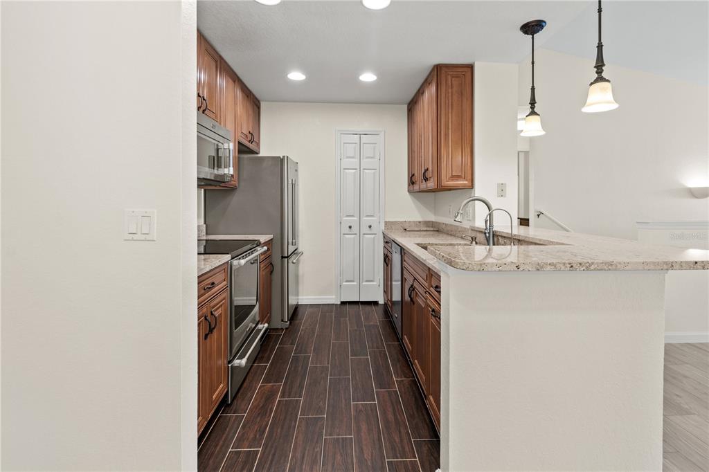 8911 Manor Loop, Unit 208 Lakewood Ranch, FL 34202 - Photo 38 of 49 a kitchen with refrigerator and sink