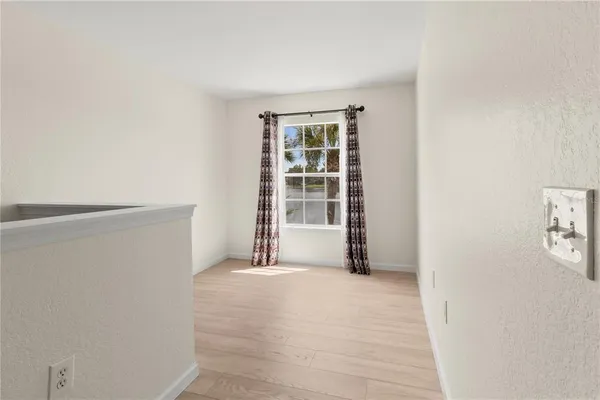a view of kitchen with livingroom and wooden floor