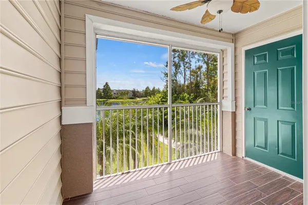a view of a balcony with floor to ceiling windows and wooden floor
