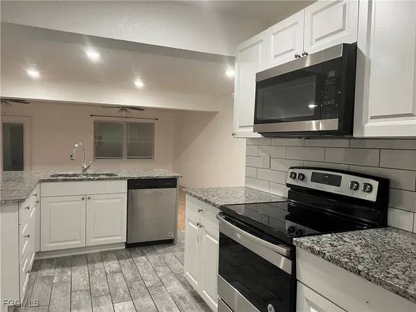 a kitchen with a stove and a microwave