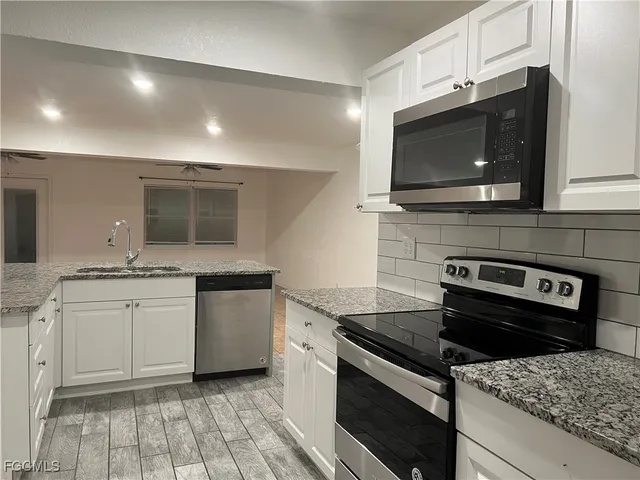 a kitchen with a stove and a microwave