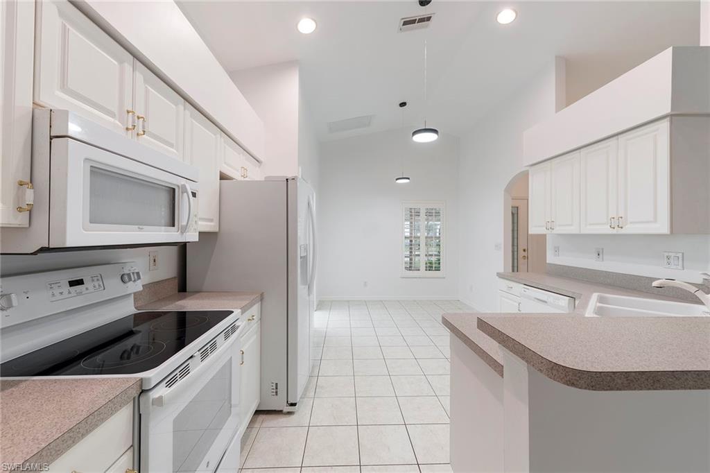 21695 Brixham Run Loop Estero, FL 33928 - Photo 11 of 32 a kitchen with a sink stove and cabinets