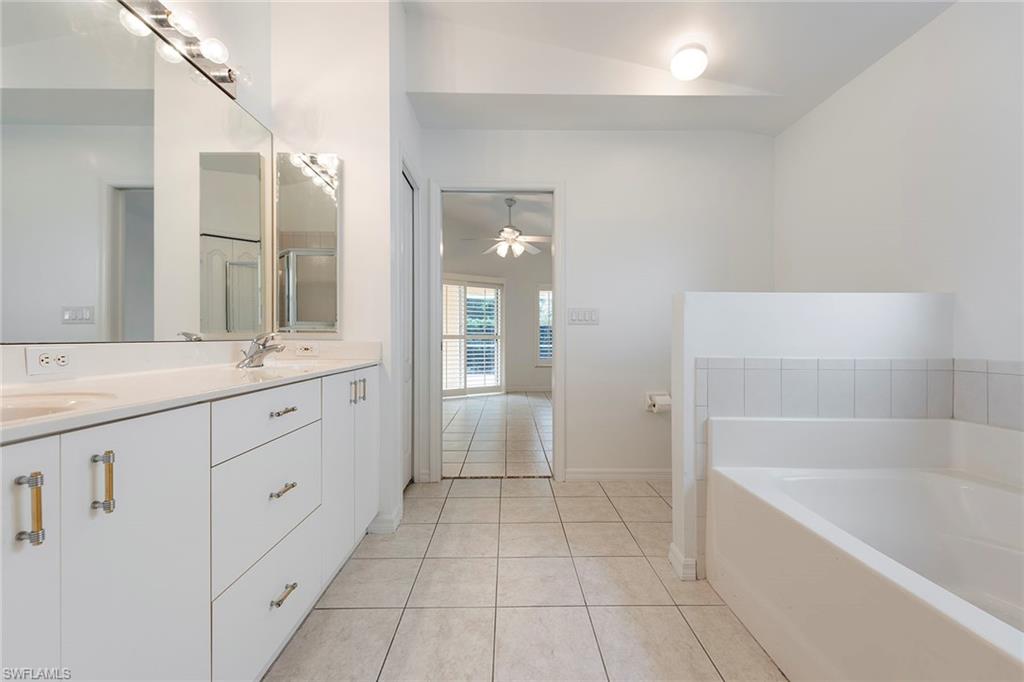 21695 Brixham Run Loop Estero, FL 33928 - Photo 20 of 32 a spacious bathroom with a bathtub sink and mirror