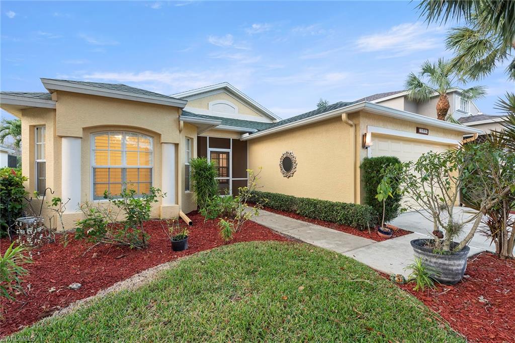 21695 Brixham Run Loop Estero, FL 33928 - Photo 2 of 32 a front view of house with yard
