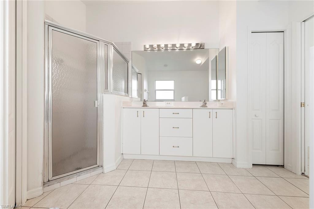 21695 Brixham Run Loop Estero, FL 33928 - Photo 21 of 32 a bathroom with a shower a sink and a mirror