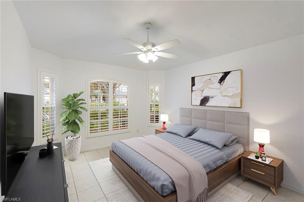 21695 Brixham Run Loop Estero, FL 33928 - Photo 6 of 32 a bedroom with a bed and a flat screen tv