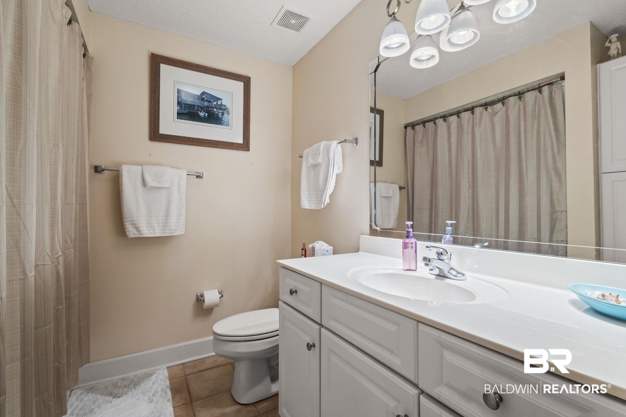 27580 Canal Road, Unit 1517 Orange Beach, AL 36561 - Photo 12 of 23 Bathroom with tile patterned flooring, vanity, and toilet